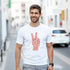 Man in white Peace graphic T-shirt with pink peace-sign hand design, heavyweight cotton blend, streetwear look.