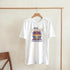 White women's cotton-blend graphic tee with Mai Tai Dreams sunset and palm trees design.