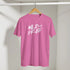 Pink T-shirt on wooden hanger with bold white WILD AND FREE slogan.