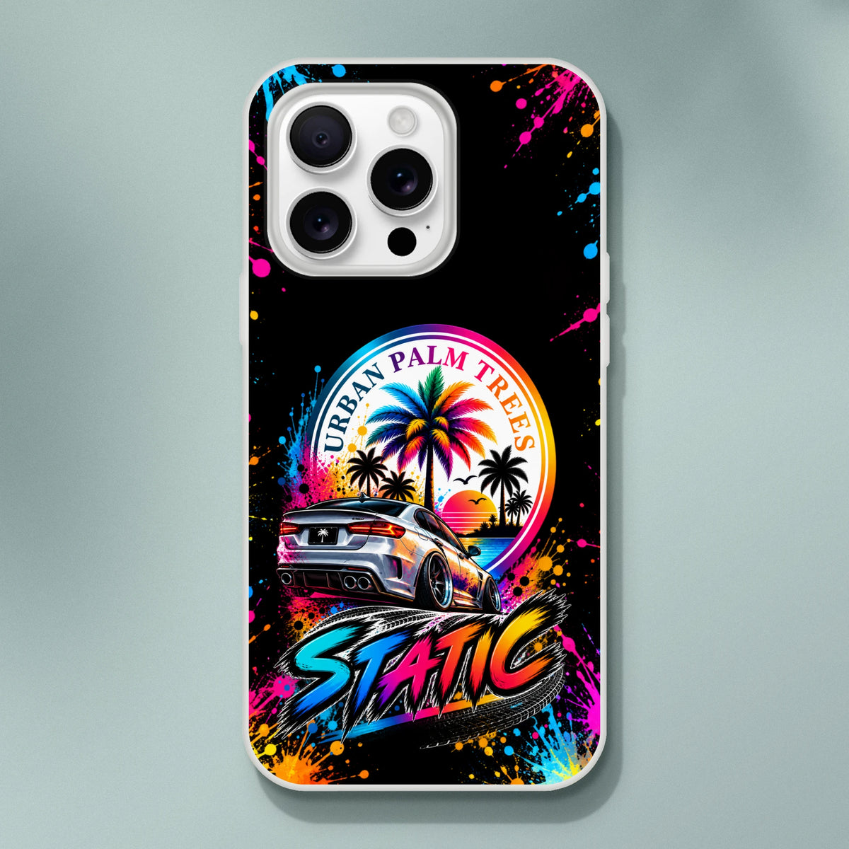 Vibrant iPhone case featuring a slammed car, neon "STATIC" typography, and colorful palm tree sunset art with paint splatter effects.