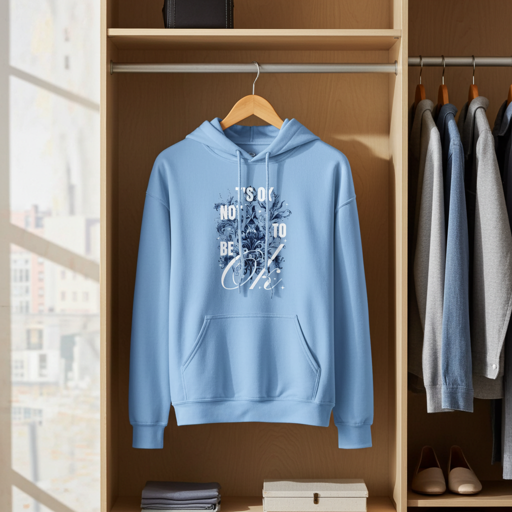 Blue hoodie with text design on a hanger in a wardrobe.