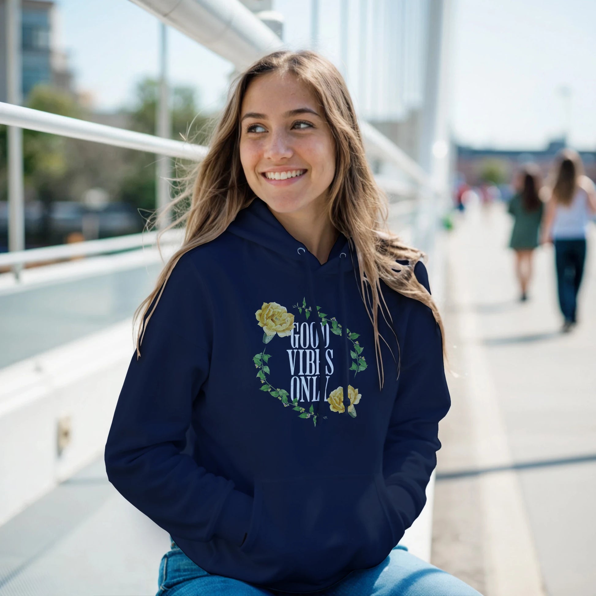 Young woman in navy Good Vibes Only hoodie with floral wreath graphic; soft 50/50 cotton-poly blend.