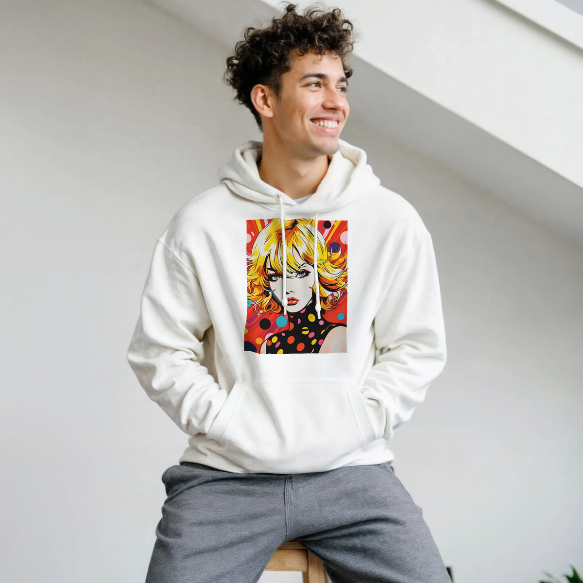 White pullover hoodie featuring a vibrant retro blonde pop art woman graphic with bold colors and polka dots.