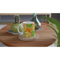 Cute Citrus Mug with orange and lime slices in a tropical fruit pattern on white ceramic.
