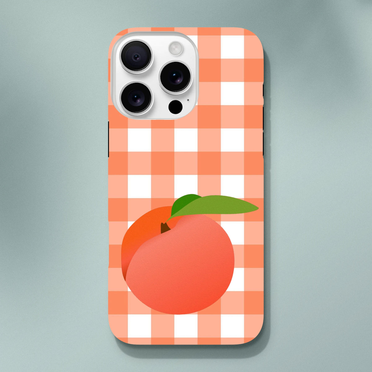 Retro peach gingham iPhone case featuring a checkered orange and white pattern with a large fruit graphic and green leaf.