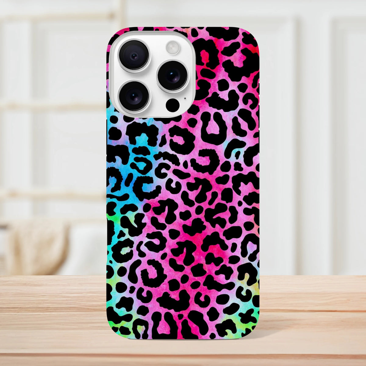 Vibrant rainbow leopard print iPhone case providing tough drop protection and bold street style for models 13 through 16.