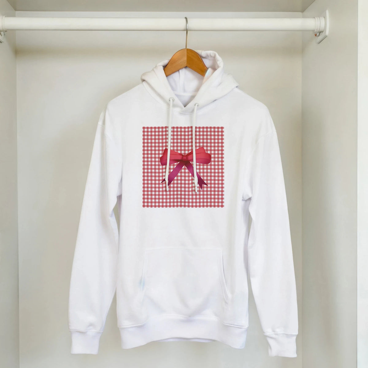 White hoodie featuring red gingham square and pink bow graphic. Cute coquette checkered pullover for women.