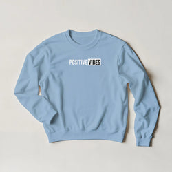 Light blue women's sweatshirt with a bold 'POSITIVE VIBES' slogan across the chest.