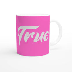 Pink Stay True mug with white script slogan, ceramic coffee cup with a white handle.
