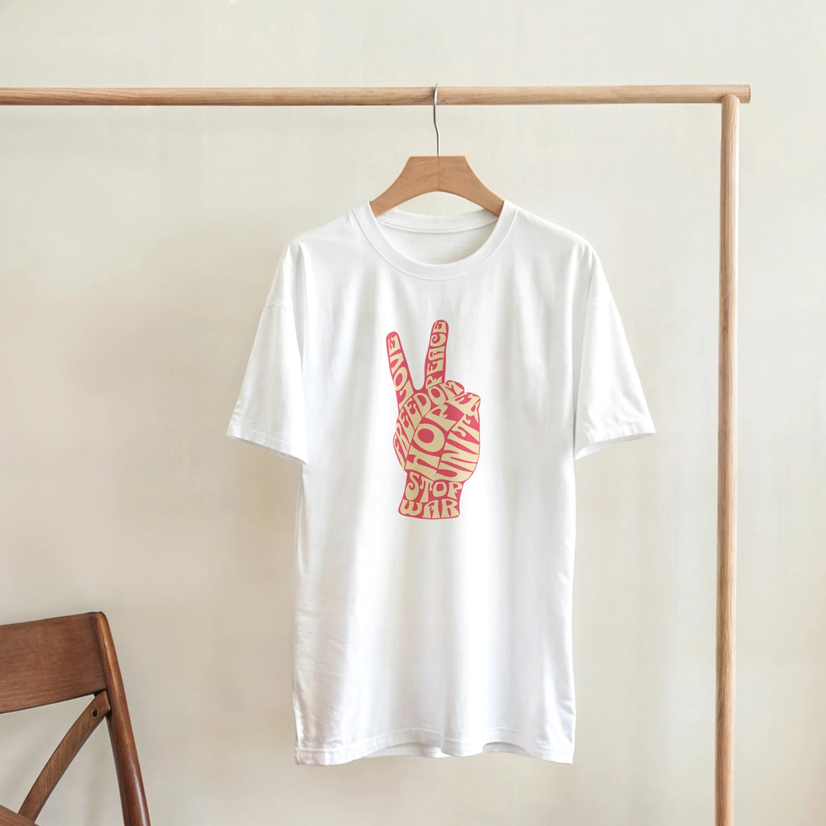 White women's peace graphic T-shirt with pink peace-hand design on front, soft cotton blend.
