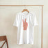 White women's peace graphic T-shirt with pink peace-hand design on front, soft cotton blend.