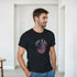 Man wearing a black Made In USA graphic T-shirt with a circular American flag design.