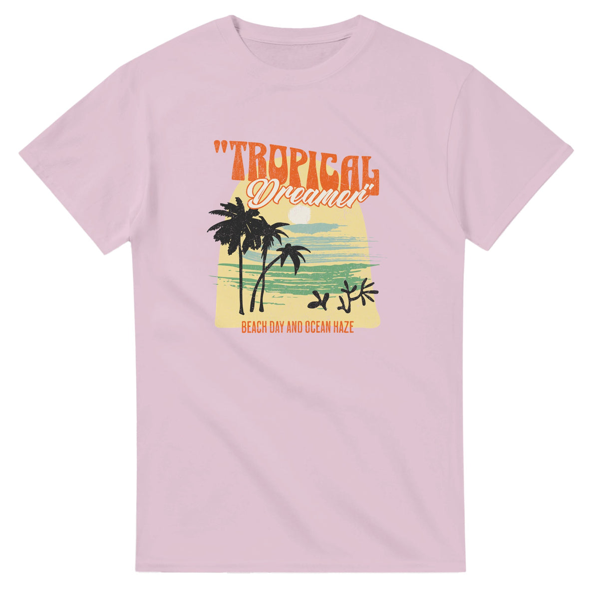 Pink women's Tropical Dreamer graphic tee with palm trees, sunset and beach scene on soft cotton blend.