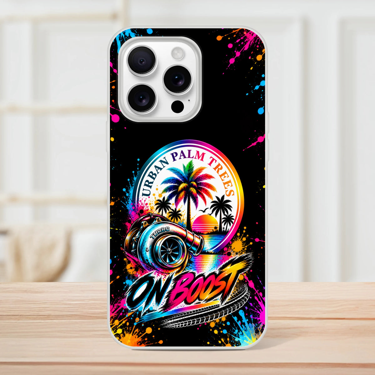 On Boost iPhone case featuring colorful turbocharger, Urban Palm Trees sunset graphic, and vibrant paint splatter design for petrolheads.
