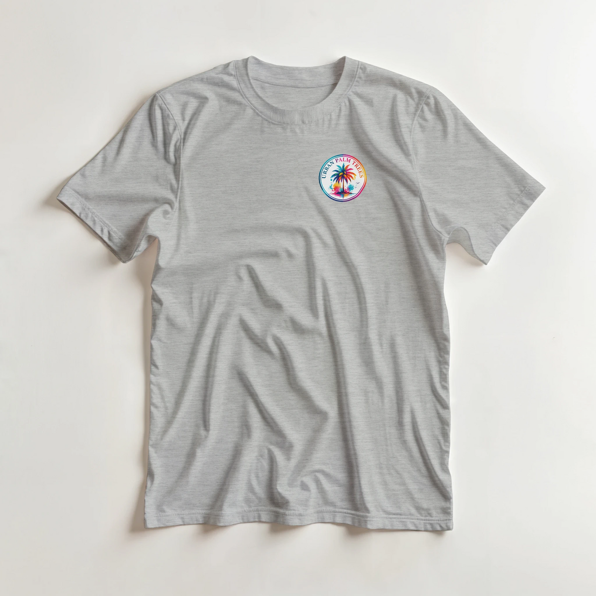 Grey men's crew neck t-shirt featuring a colorful circular Urban Palm Trees graphic on the left chest.