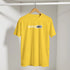 Yellow Positive Vibes T-shirt on a wooden hanger in a closet, retro slogan streetwear look.