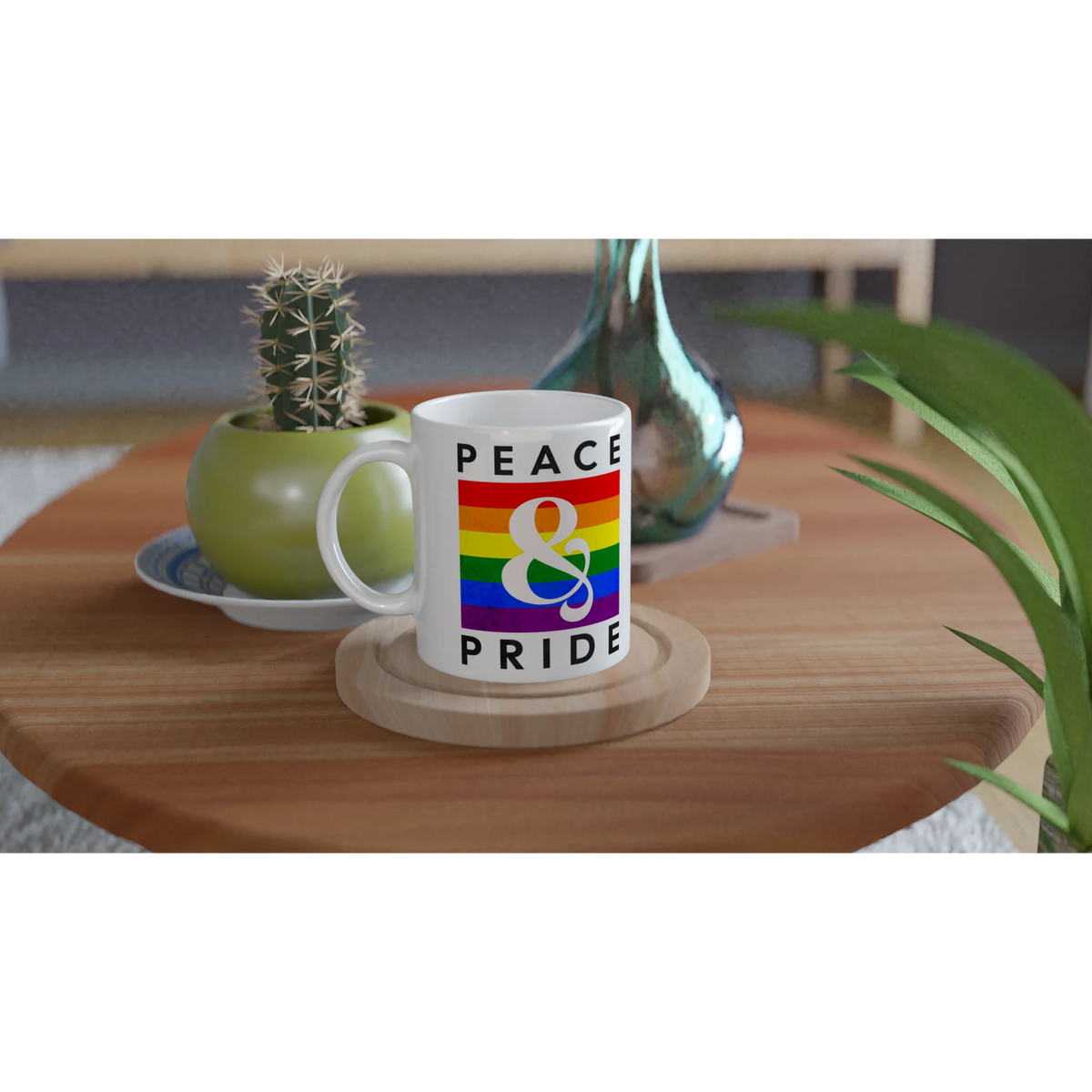 White ceramic Gay Pride mug with rainbow PRIDE design, LGBTQ coffee cup on a wooden table beside a cactus.