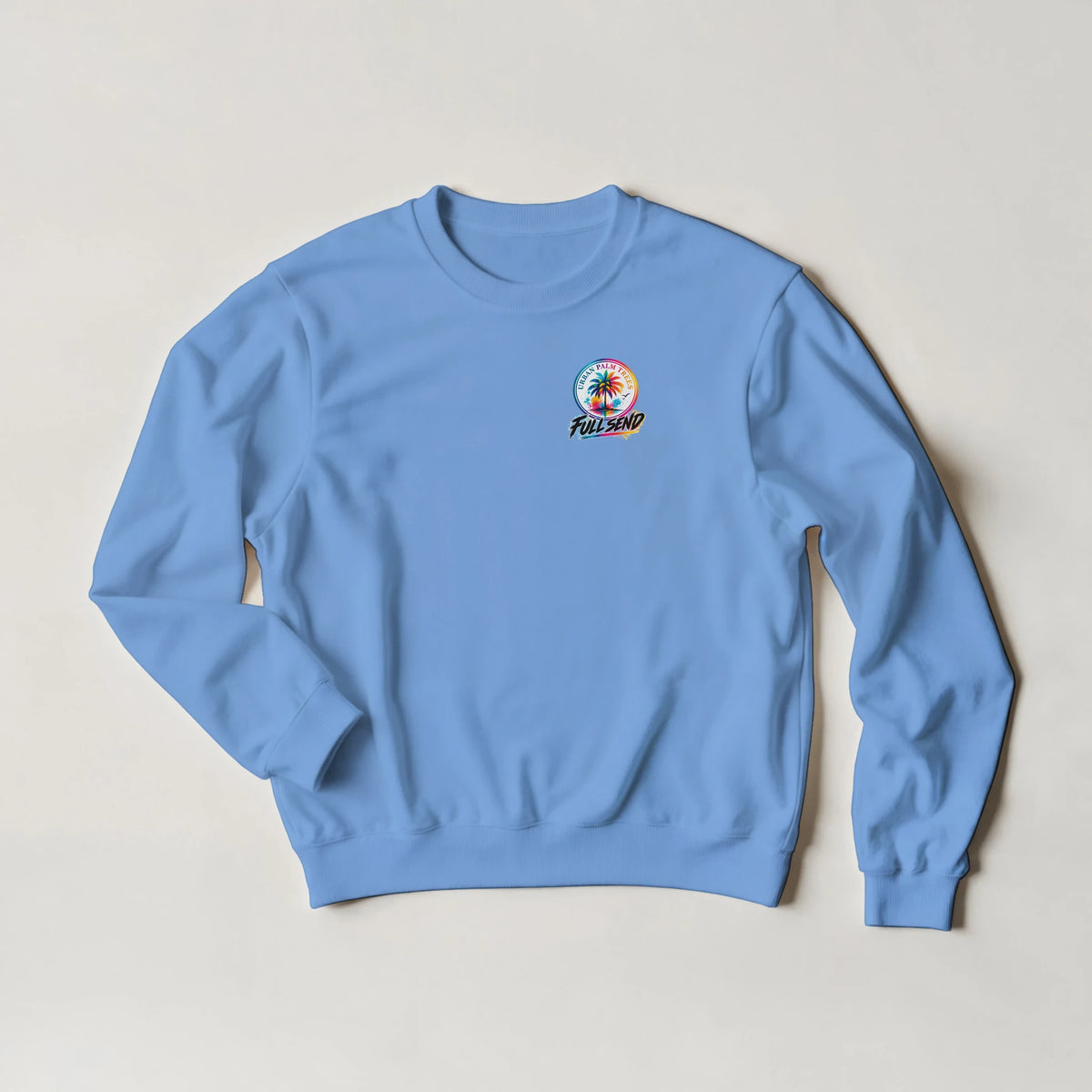 Light blue Tucked Petrolhead sweatshirt featuring a colorful palm tree and Full Send graphic, representing modified car culture streetwear.
