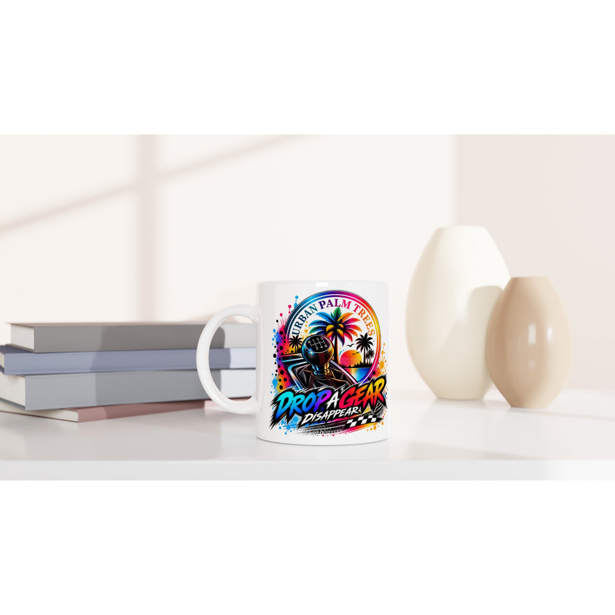 White car enthusiast mug featuring colorful "Drop A Gear" gear shift graphic and palm trees, perfect for coffee or tea.
