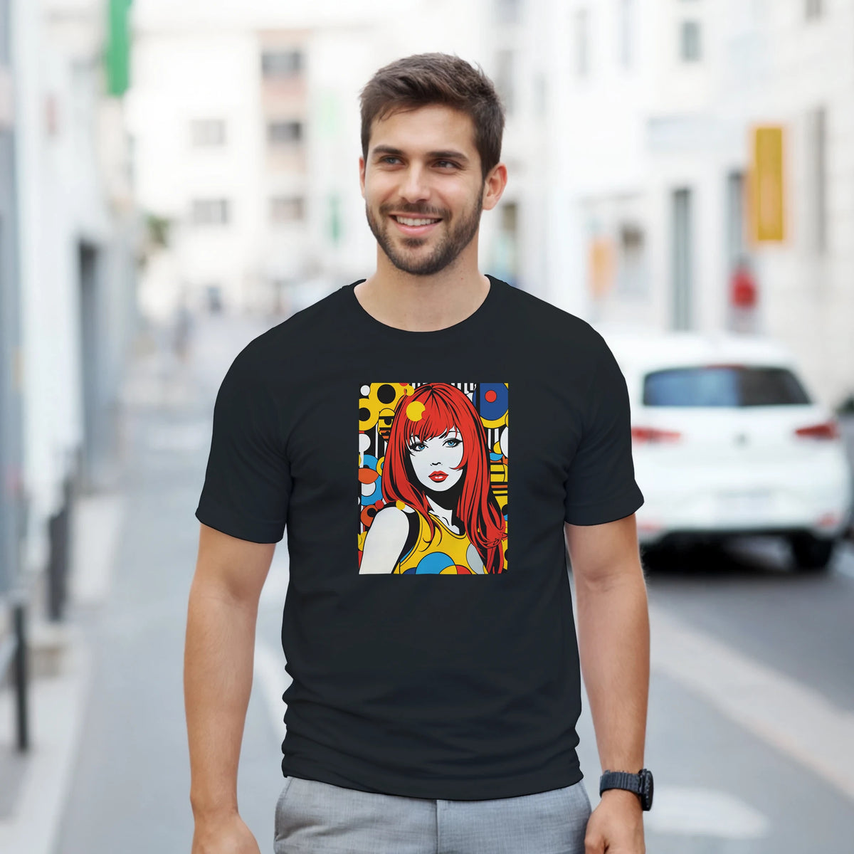 Man wearing black t-shirt featuring a colorful retro pop art girl print with red hair and bold geometric 70s streetwear design.