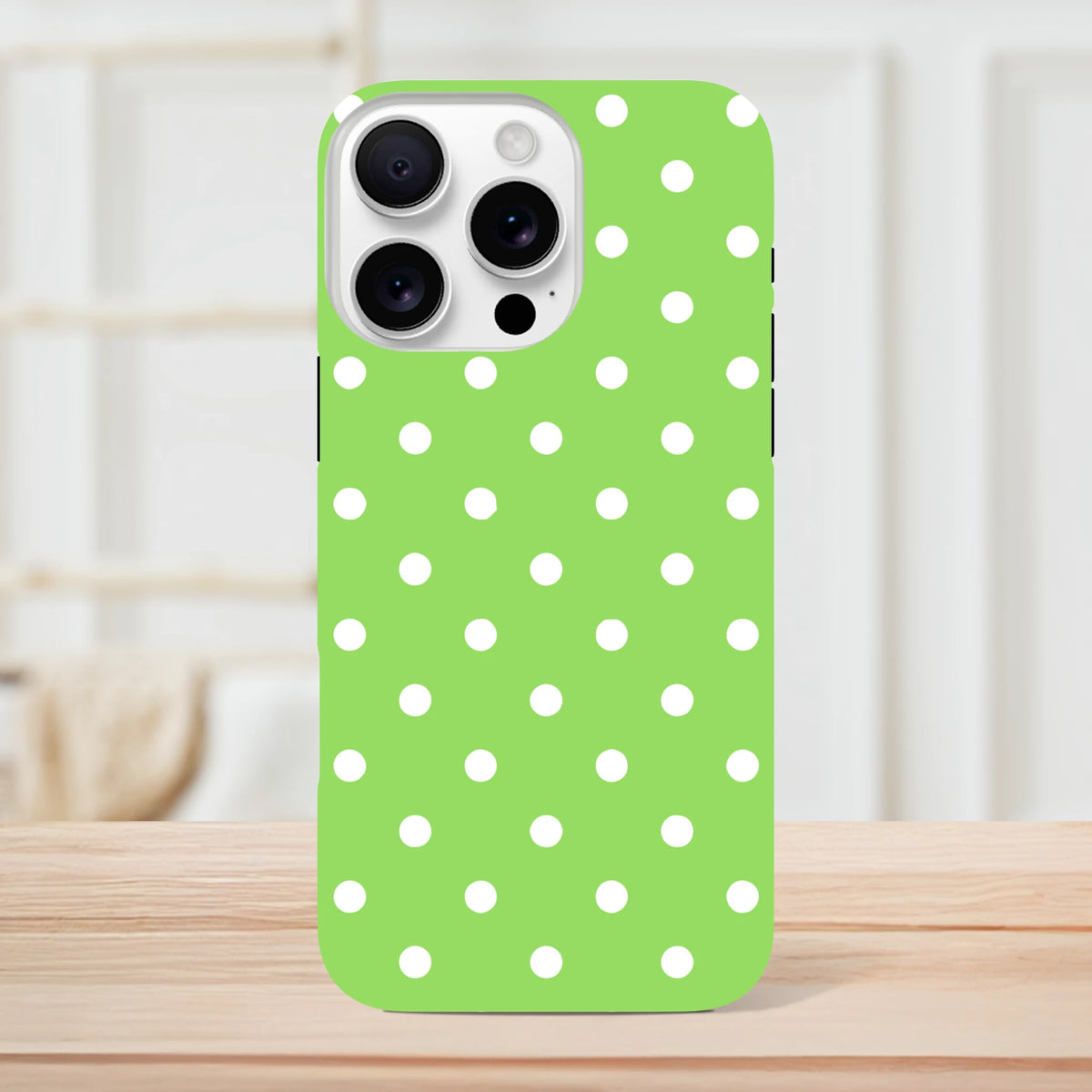 Green and white polka dot tough iPhone case featuring a cute design and dual-layer shock absorption for drop protection.