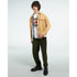 Male model wearing a white Japanese JDM graphic T-shirt under a tan jacket, olive pants, black shoes.
