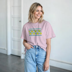 Smiling woman wearing pastel pink T-shirt with striped panel and gold star graphic, retro aesthetic.