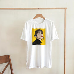 White graphic T-shirt on a wooden hanger, featuring a bold pop-art portrait in a yellow panel.