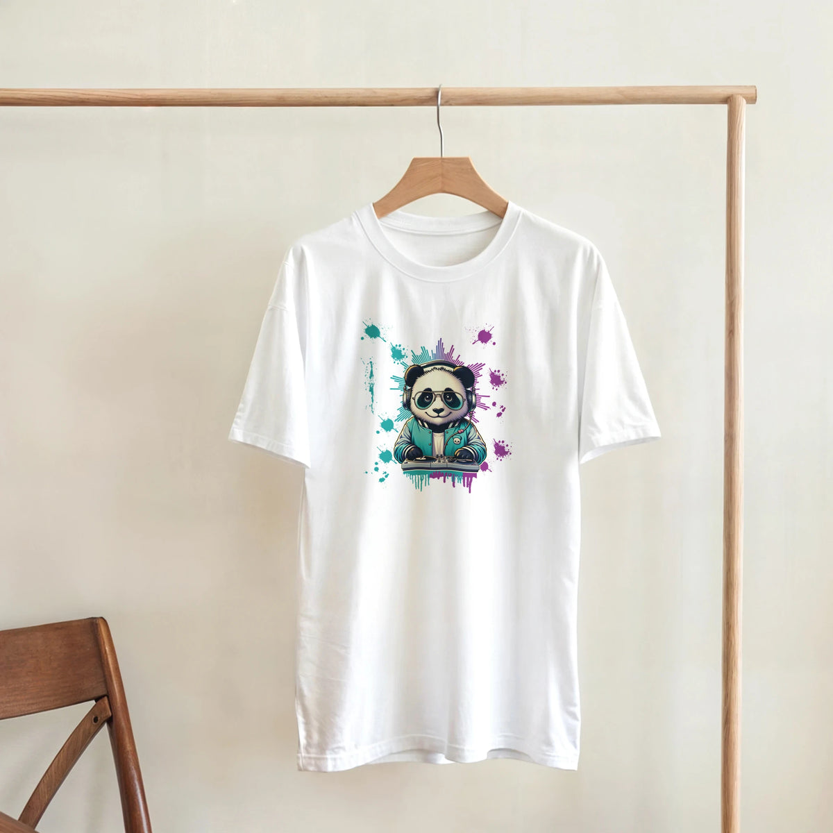 White T-shirt on a wooden rack featuring a colorful panda graphic with paint splashes.