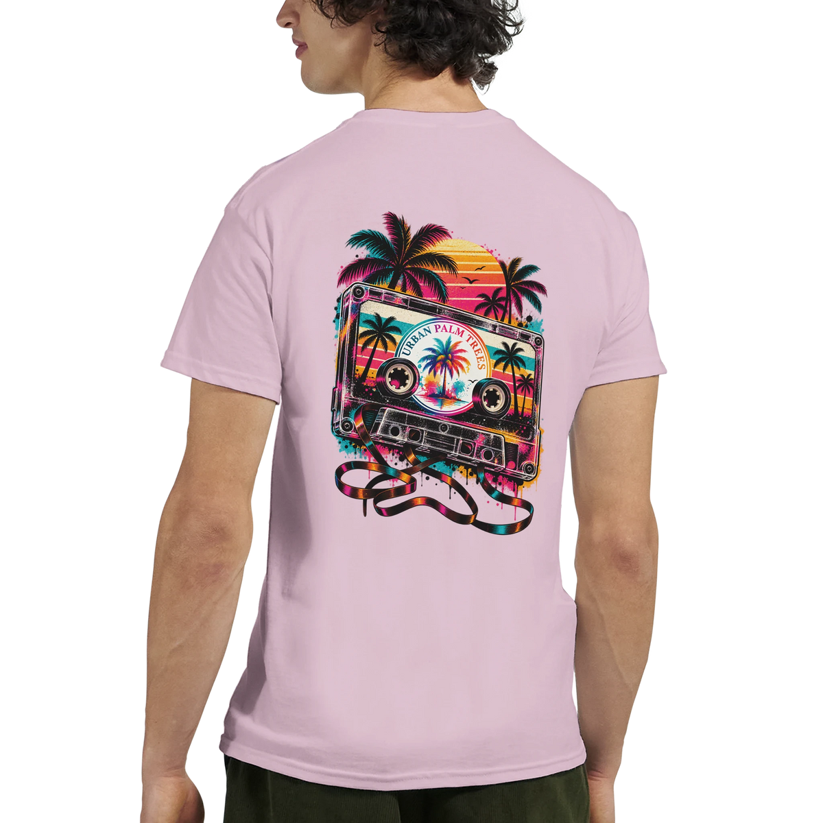 Pink men's tee back featuring retro cassette tape with palm trees and vibrant sunset graphic design.