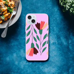 Pastel pink floral iPhone case with vintage botanical artwork and camera cutout on a blue surface beside a pasta plate
