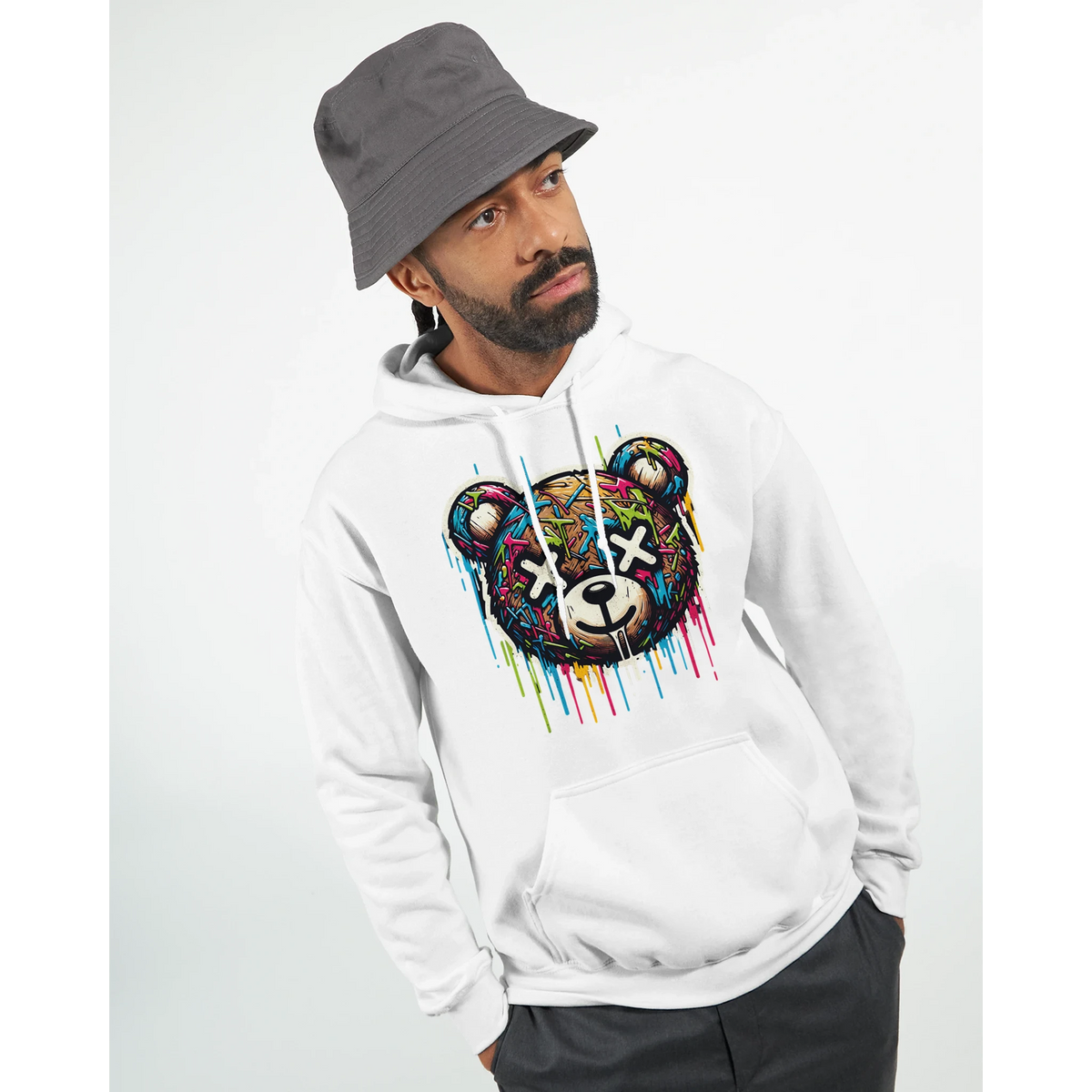 Man modeling Men's Teddy Bear Hoodie in white cotton blend with a colorful dripping bear graphic; sizes S to XL.