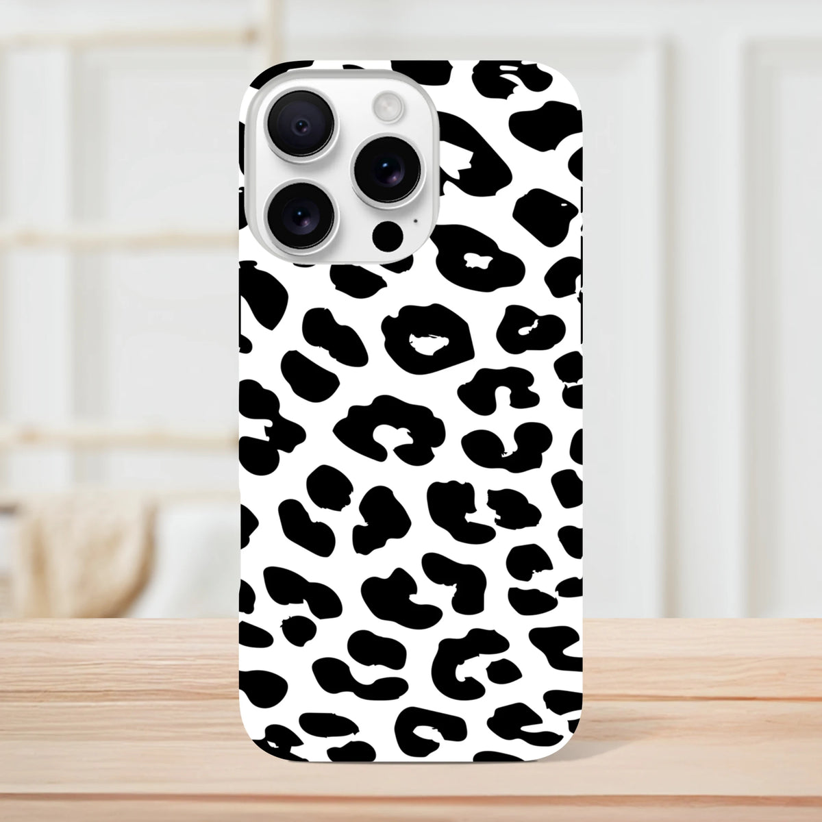 Black and white snow leopard print tough iPhone case. Shock-absorbing animal print cover for iPhone 13-16.