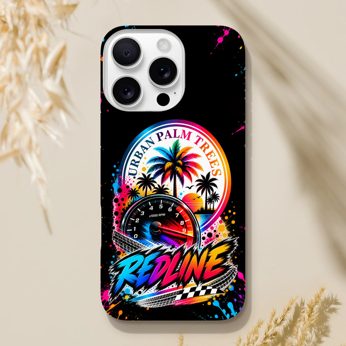 Tough iPhone case featuring a retro street racing design with a tachometer, colorful Urban Palm Trees sunset, and bold Redline text over a black background with paint splatters.