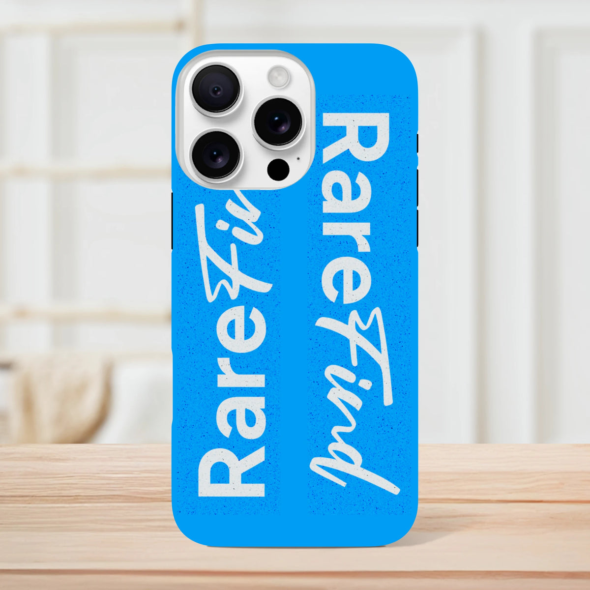 Rare Find blue tough iPhone case with white slogan text, featuring a streetwear-style design for iPhone 13-16 models.