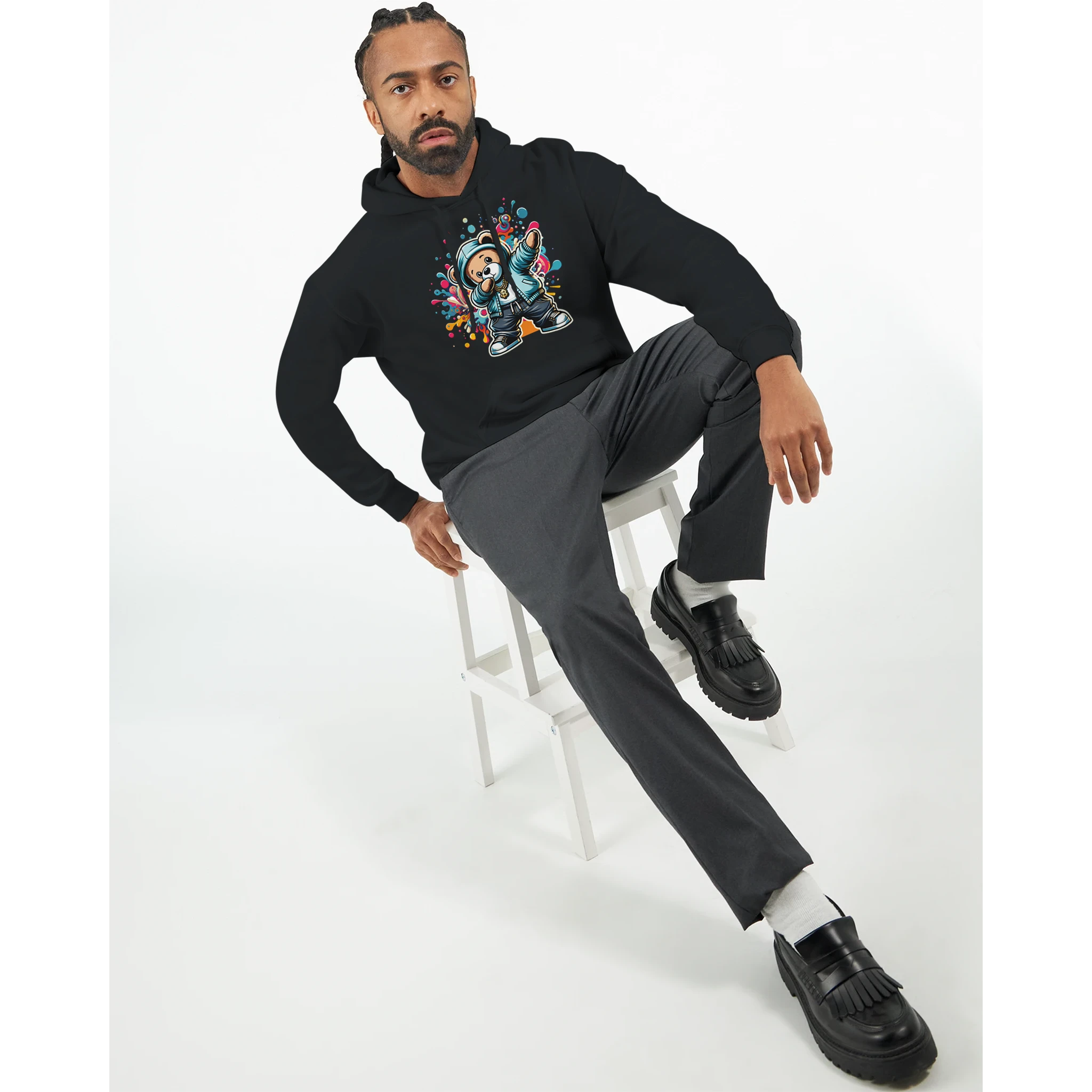 Man wearing black Men's Dab Teddy Bear Hoodie with a colorful teddy bear graphic; cotton-poly blend, casual look.