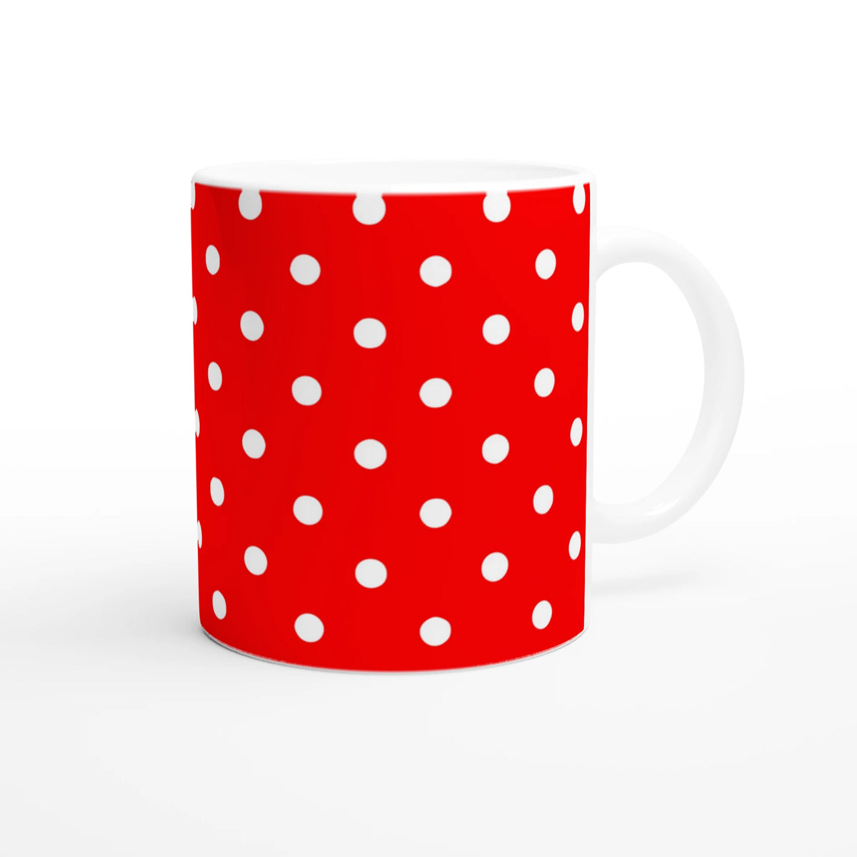 Red ceramic mug with white polka dots and white handle. Cute spotty coffee cup for daily brew, office, or gifting.