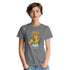 Young woman wearing grey Fresh Juice graphic tee with orange juice carton and citrus fruits.