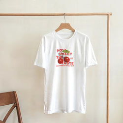 White tee with retro red cherry graphic and "HOW SWEET THE TASTE" text, a cute fruit graphic shirt for women.