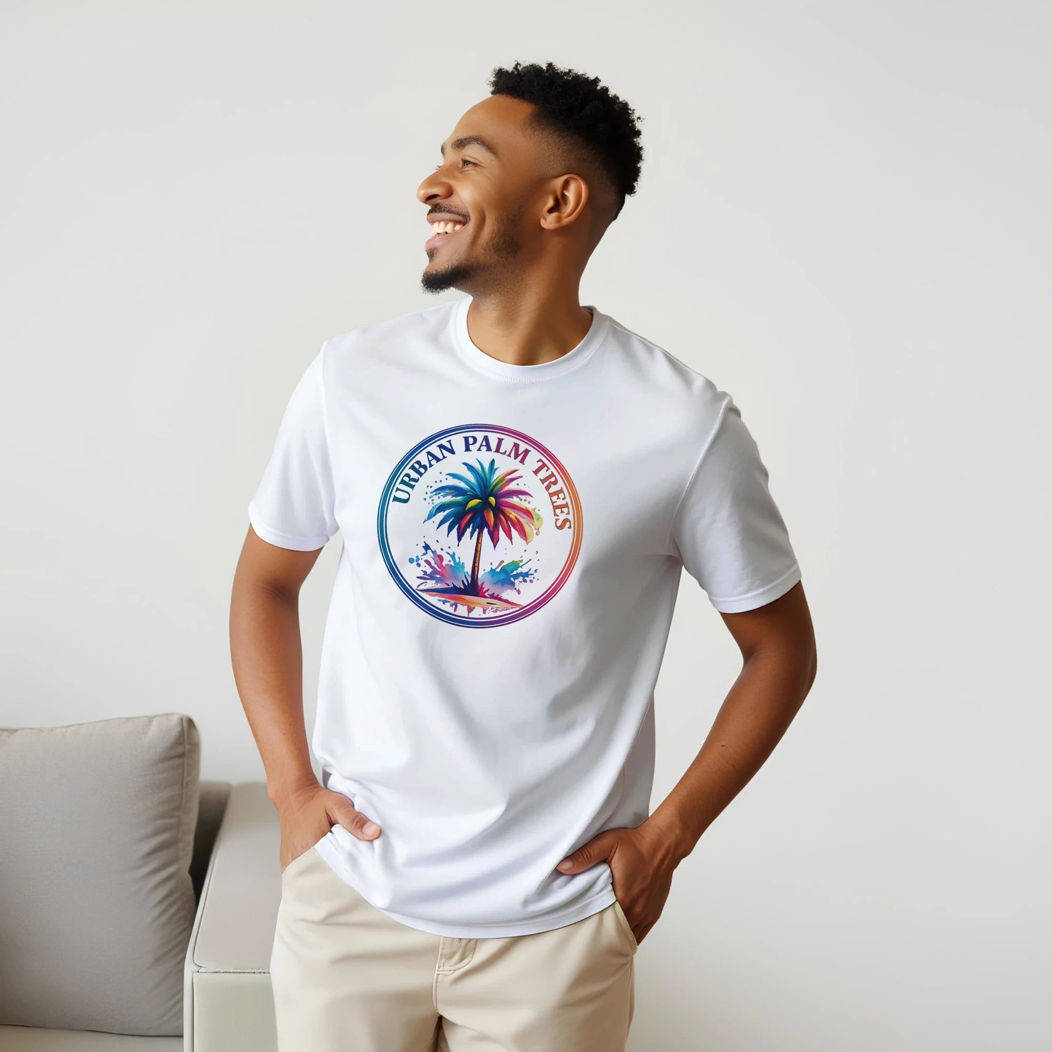 Smiling man wearing a white retro palm tree T-shirt with a vibrant circular palm graphic.