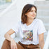 Woman wearing a white Tequila women's graphic T-shirt with a tropical scene.