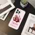 Phone case with cherry design and 'Sweet Cherries' text on a table with books and a plant.