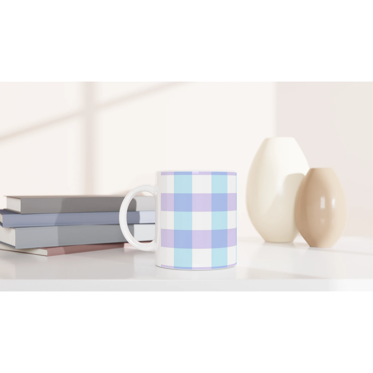 Pastel Blue Gingham Ceramic Mug with a checkered pattern on a white desk among other mugs.