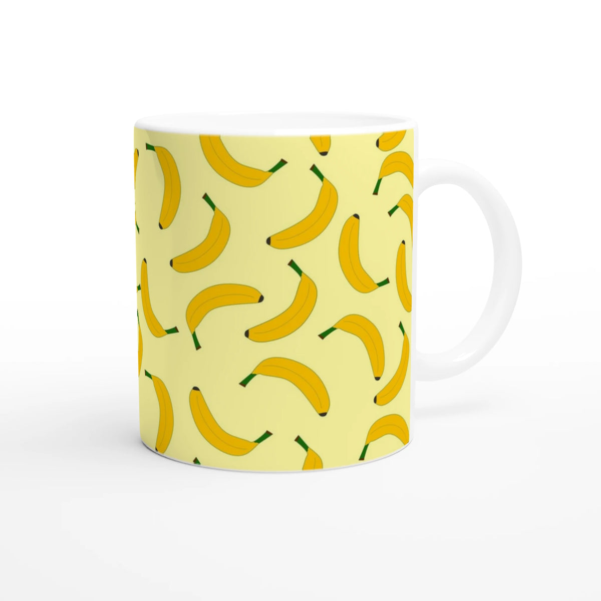 Yellow banana-pattern mug with white interior and handle.