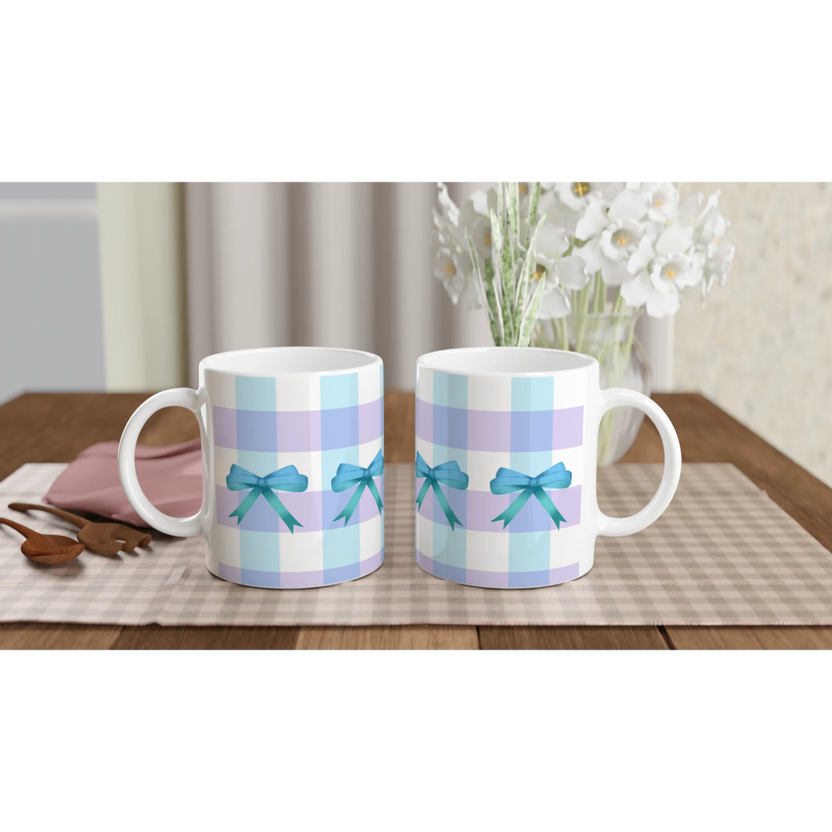 Blue Gingham Bow Mugs with pastel blue stripes and teal bows on a checkered table, bouquet in background.
