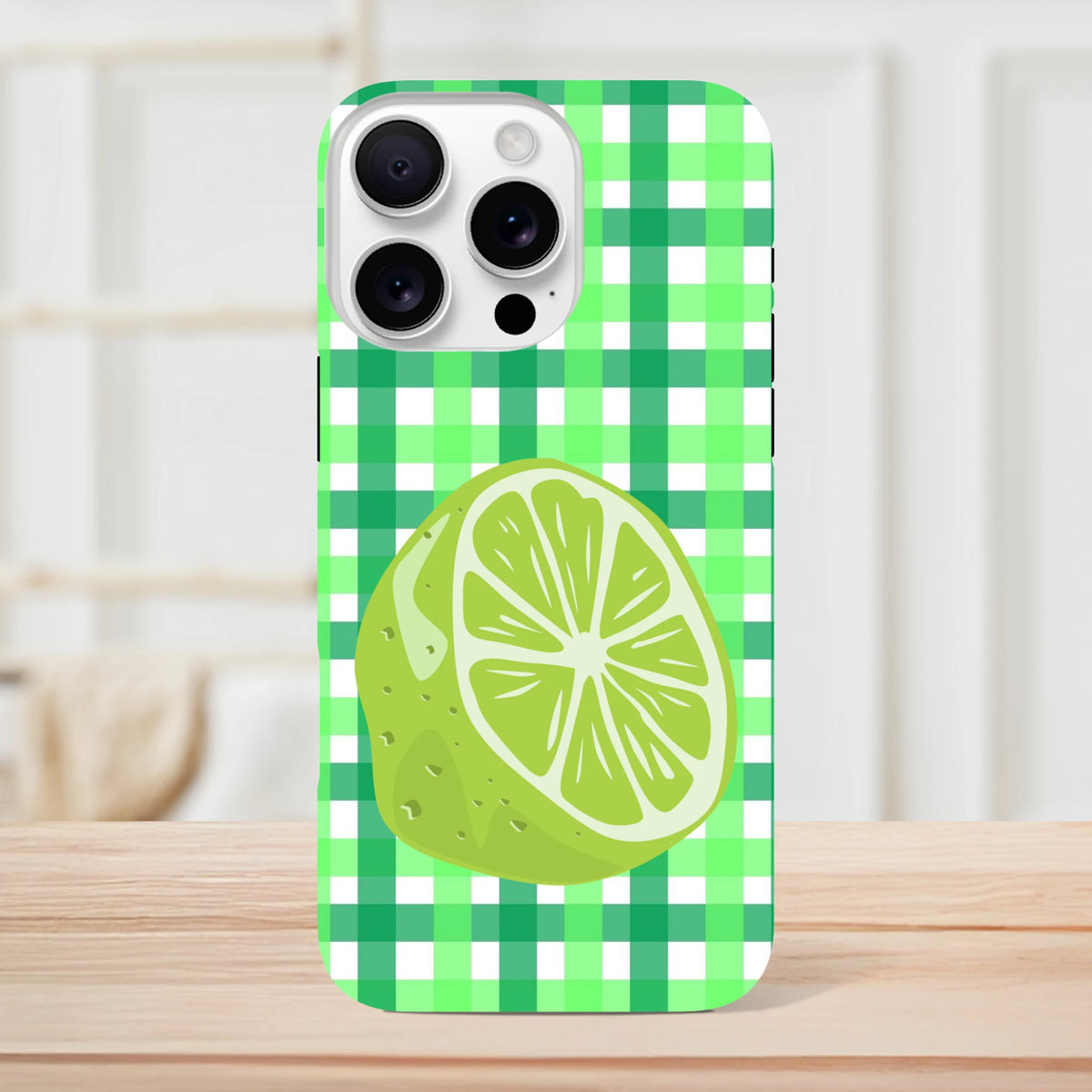 Lime gingham iPhone case featuring a vibrant citrus slice on a green checkered background for shock-absorbing protection.