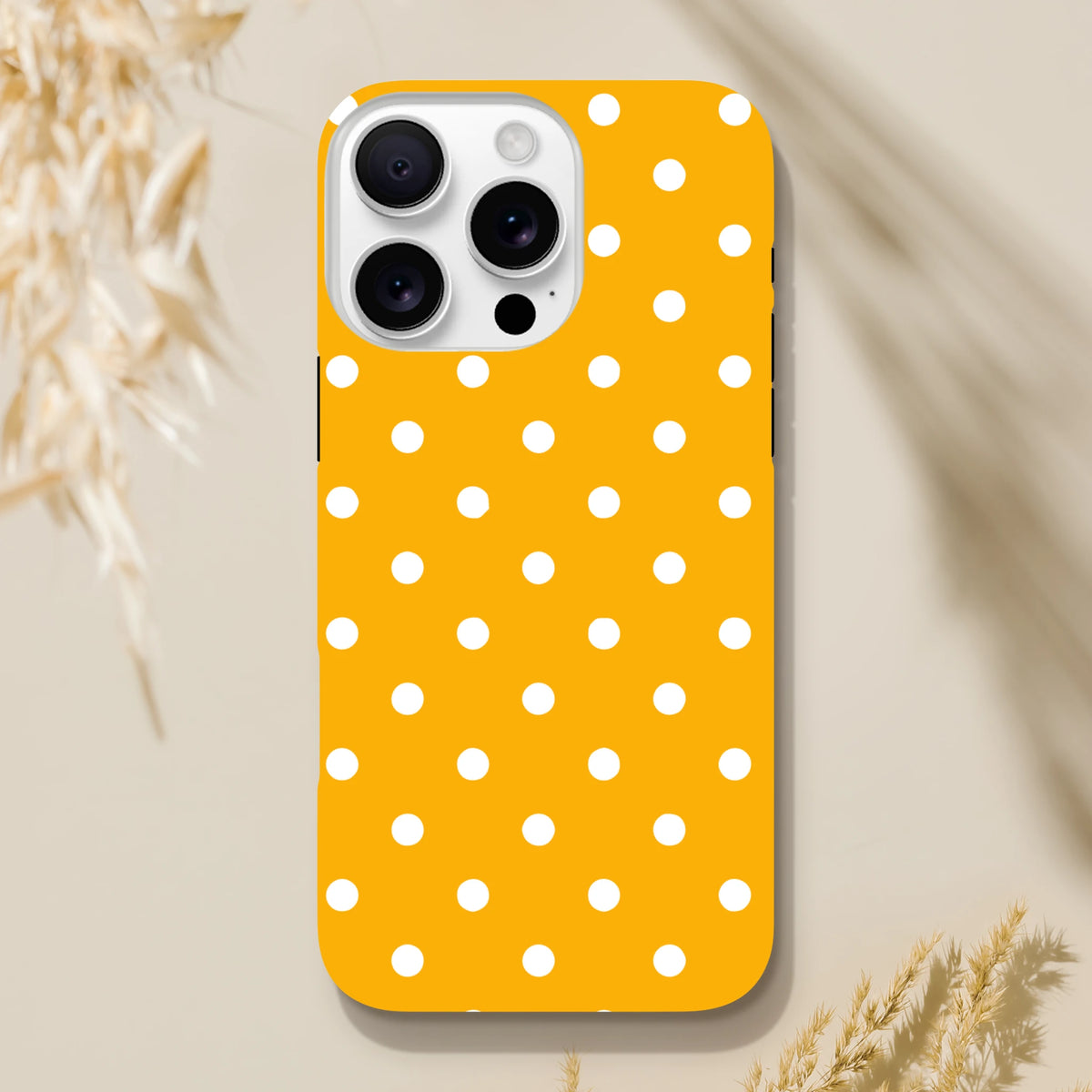 Orange and white polka dot tough iPhone case with shock-absorbing dual-layer TPU shell for models 13-16.