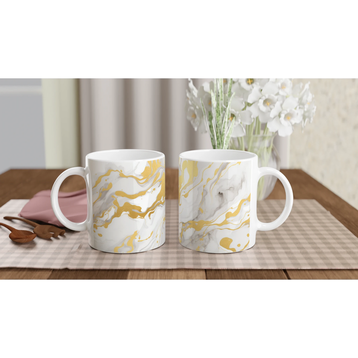 Gold and white marble mugs with abstract yellow swirls, ceramic coffee cups on a checkered table.
