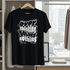 Black t-shirt with white text on a hanger in a room with a window view.