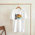 White cotton-blend Miami graphic T-shirt with a palm-tree sunset over the ocean in blue, pink, and yellow.